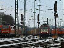 Crossrail 185 599-8 am 18.01.2013 mit einem Containerzug bei der Ausfahrt in Aachen West Richtung Kln. Links schiebt 111 010 den RE 4, rechts warten 185 386-0 und 185 229-2 mit einem Kesselzug auf Ausfahrt.