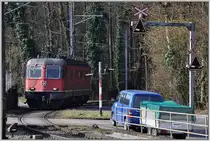Die Re 6/6 11640  M�nchenstein  entschwindet durch eine scharfe Rechtskurve beim Bahnhof H�ntwangen-Wil in den Wald Richtung Kiesverladeanlage. (08.03.2013)