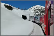 Etwas weiter oben. R1656 mit den ABe 4/4 III 51  Poschiavo  und 53  Tirano  zwischen Alp Gr�m und Ospizio Bernina auf der Bernina S�dseite. (15.04.2013)