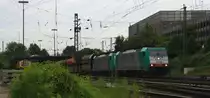 Zwei Cobra 2808 und 2819 kommen mit einem langen Kalkzug aus Yves-Gomez�e(B) nach Millingen und fahren in Aachen-West ein und auf dem Nebengleis steht eine Stopfmaschine und ein Schotterprofiliermaschine steht auf dem abstellgleis in Aachen-West in der Abendsonne und Wolken am Abend vom 26.6.2013.