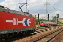 Hier 185 585-7 mit einem Kesselwagenzug und im Hintergrund 442 329-9 als RB14 (RB18570) von Senftenberg nach Berlin Sch�nefeld Flughafen, diese beiden Z�ge begegneten sich am 1.7.2013 in Berlin Sch�nefeld Flughafen.