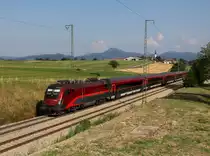 Die 1116 215 mit einem RJ am 24.08.2013 unterwegs bei Stra�.