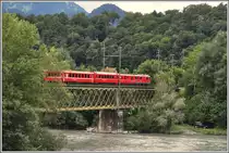 RE1224 nach Disentis/Must�r mit Ge 4/4 II 614  Schiers  auf der Hinterrheinbr�cke in Reichenau-Tamins. (10.09.2013)