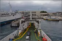 <U>Zwischen Skylla und Charybdis.</U>

Das Fährschiff der FS erreicht den Fährhafen und Bahnhof von Messina. Die Bahnsteige sind rechterhand der Bäume versteckt, linkerhand die Gleise um auf die Schiffe zu rangieren. Während die Fata Morgana, der Fotostandpunkt, unermüdlich die Personen und Fahrzeuge zwischen dem Festland und Sizilien herschüttelt, scheint das Schiff auf einen Zug zu warten. Messina im August 2013. 