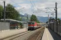 1144 221 mit REX 1506 Salzburg Hauptbahnhof-W�rgl Hauptbahnhof auf Bahnhof Brixen im Thale am 31-7-2013.