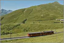 Während im Vordergrung ein älterer Jungfraubahn-Triebzug dem Jungfraujoch zu strebt, ist im Hintergrund ein talwärtsfahrender WAB Zug zu erkennen.
Ganz rechts im Bild, und nur angedeutet, die Station  Kleine Schiedegg .
21. Aug. 2013