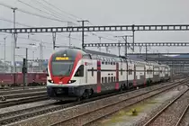 RABe 511 110 durchfährt den Bahnhof Muttenz. Die Aufnahme stammt vom 16.02.2014.