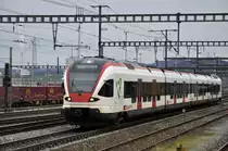 RABe 521 022 auf der S1 fährt in den Bahnhof Muttenz ein. Die Aufnahme stamm vom 16.02.2014.