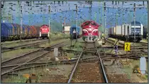 Der tiefe Blick hinein in die Gleisanlagen von Komárom.Links im Bild eine Rangierlok
deutscher Bauart ( Ex 290),ein ausfahrender Personenzug nach Budapest,eine Nohab Lok
und rechts die Siemens Lok der Metrans. Szenario vom 20.Mai 2014.