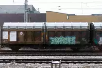 Der gleiche Wagen- eigentlich sind es ja 2 kurzgekuppelte Waggons. Mehr zu ahnen als zu sehen- auf dem rechten Seitenwandsegement der Schriftzug  Nord- ....Waggon stand auf dem anderen Teil. Alles schon abgedeckt durch Graffity und Schmutz. 
Dieser Doppelwagen wurde einmal für die  Nordwaggon  gebaut, hinter der ein bekannter Möbelhersteller steckte (Regal  Billy  usw.). Es dürfte sich dabei um einen Doppelwagen aus der Lieferung vom Werk Niesky aus den 80-ern handeln.  Später gingen sie in den Bestand der TRANSWAGGON über. Aufgenommen am 27.12.14 in Hennigsdorf.
