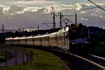 Triebzug RBDe 561 082 mit EW 1 Bodan 1.Klasse Wagen braust im Gegenlicht in Bollingen vorüber.Bild vom 27.7.2015