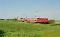 111 084 fuhr am 05.06.2015 mit einem RE von Emden nach Münster, hier bei Petkum.