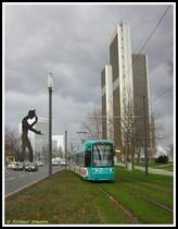 S-Triebwagen 202 am 13.02.2007 auf dem 7. Zug der Linie 16 nach Stadtgrenze Offenbach kurz vor der Haltestelle Festhalle/Messe. Am Bildrand links ist das Kunstwerk  Hammering Man  des US-amerikanischen K�nstlers Jonathan Borofsky zu sehen.