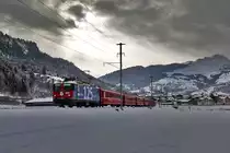 Bei einer sehr kurzen Aufhellung im Oberland fährt die Ge 4/4 II 623 mit einem Re aus Disentis nach Landquart in Castrisch vorüber.Bild vom 20.1.2016