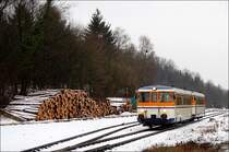 Zwei MAN-Schienenbusse der SWEG fahren am 10.02.2006 als SWE 70781 von Neckarbischofsheim Nord nach Aglasterhausen, als sie bei der Einfahrt in den Bahnhof von Aglasterhausen fotografiert werden konnten. Bei der links zu erkennenden Stammholzansammlung handelt es sich um Holz, welches von der SWEG bis nach Meckesheim gebracht wird, von wo es mittels einer V 90 nach Mannheim Rangierbahnhof transportiert wird. Bedingt durch den Umbau des Meckesheimer Bahnhofs, bei dem einige Gleise entfernt wurden, ist es seit Ende Juli 2007 nicht mehr m�glich, die Wagen in Meckesheim zu rangieren, weshalb es zu einer vollst�ndigen Verlagerung des Transports auf die Stra�e gekommen ist.