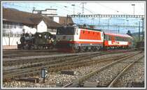 Zum 75 Jahr Jubil�um der Chur - Arosa Bahn wurden 1987 auf der Stadtstrecke Dampffahrten mit G3/4 1  Rh�tia  angeboten. Zu Besuch war auch ein Sonderzug aus �sterreich, gezogen von der 1044 501-3, hier bei der gleichzeitigen Einfahrt in Chur.