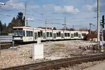 rnv-Tramwagen 1042  100 Jahre Rhein-Haardtbahn  als Linie 4 (Oggersheim Endstelle - Heddesheim Bahnhof), bei der Ausfahrt aus dem Bahnhof Käfertal.
Aufgenommen am 24.3.2016.