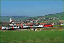Ein InterRegio mit Doppelstock-Wagen ist im Fricktal unterwegs  nach Z�rich. Links im Bild ist die m�chtige Barockkirche von Frick (Aargau) aus dem Jahre 1716 gut zu erkennen. 1.4.2007
