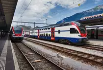 Links der RABe 511 026 als RE 4872  RHEINTAL-EXPRESS  (Chur - St. Gallen - Wil SG) und rechts der RABe 511 046 als RE 5070 (Chur - Zürich HB).
Aufgenommen am 21.7.2016, in Chur.