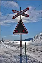 Die Blinklichtanlage am Lago Bianco ist auch jetzt für Wintersportler in Betrieb, die hier das Trassee der Berninabahn überqueren müssen. (22.12.2016)