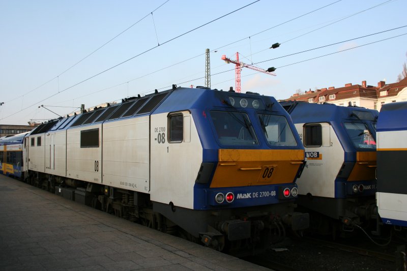Zwei NOB-Zge wechseln sich ab. Der hintere als Sandwich eingeklemmte Zug mit NOB DE 2700-05 will nach Westerland und der vordere mit NOB DE 2700-08 ist gerade von dort angekommen.
Hamburg-Altona am Morgen des 19.4.2008.